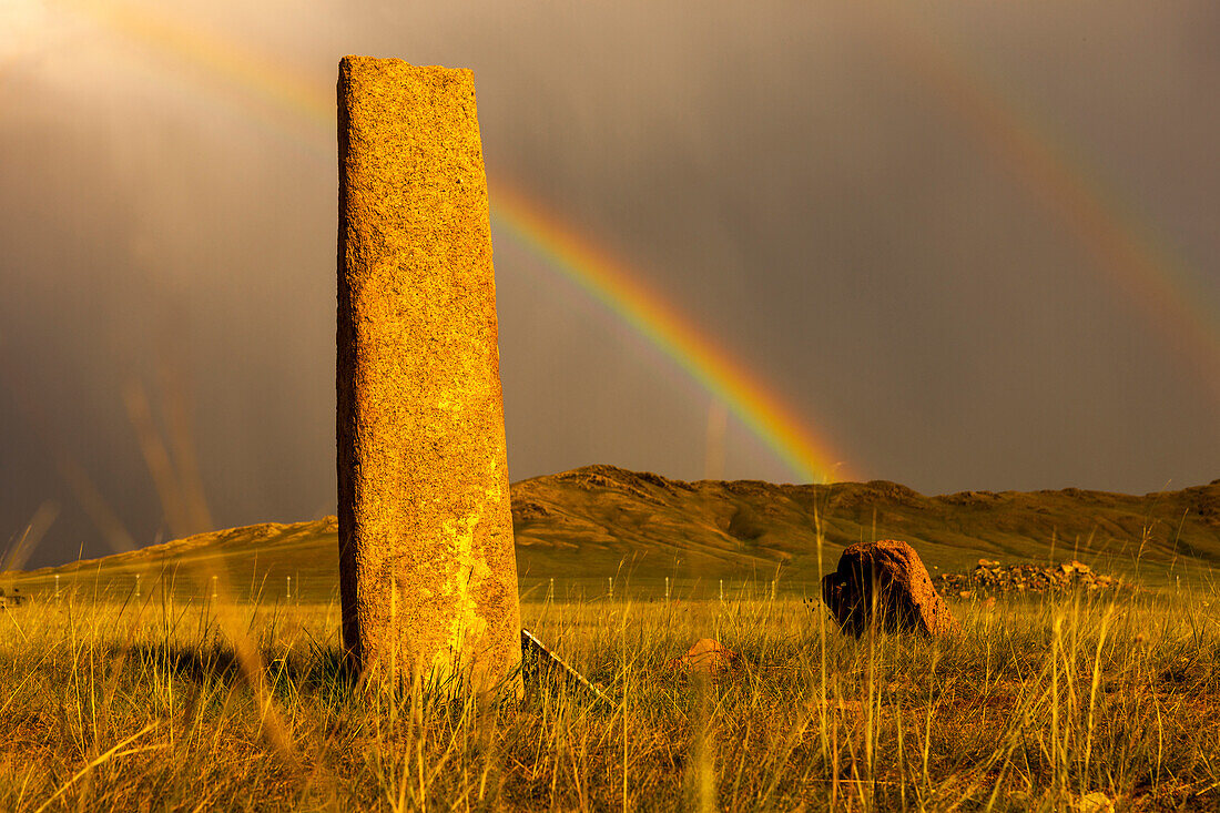 Rainbow over Deer stones with inscriptions, 1000 BC, Mongolia.