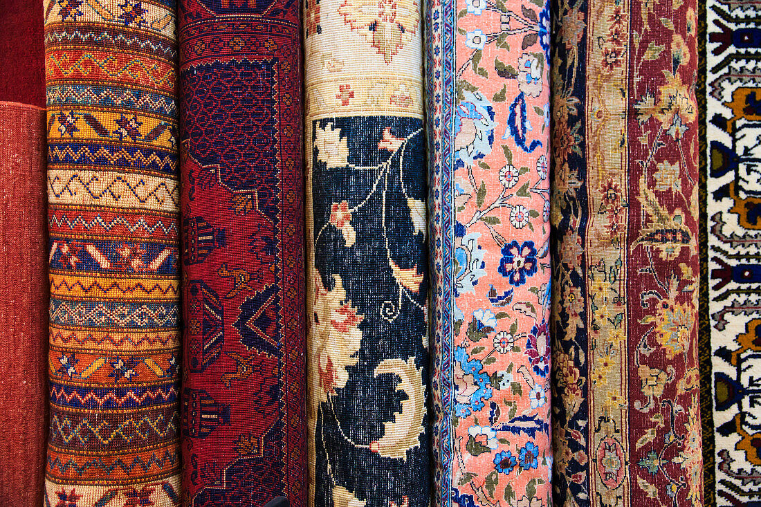 Turkey, Izmir Province, Selcuk, rolled and stacked rugs. Varieties of traditional patterns.
