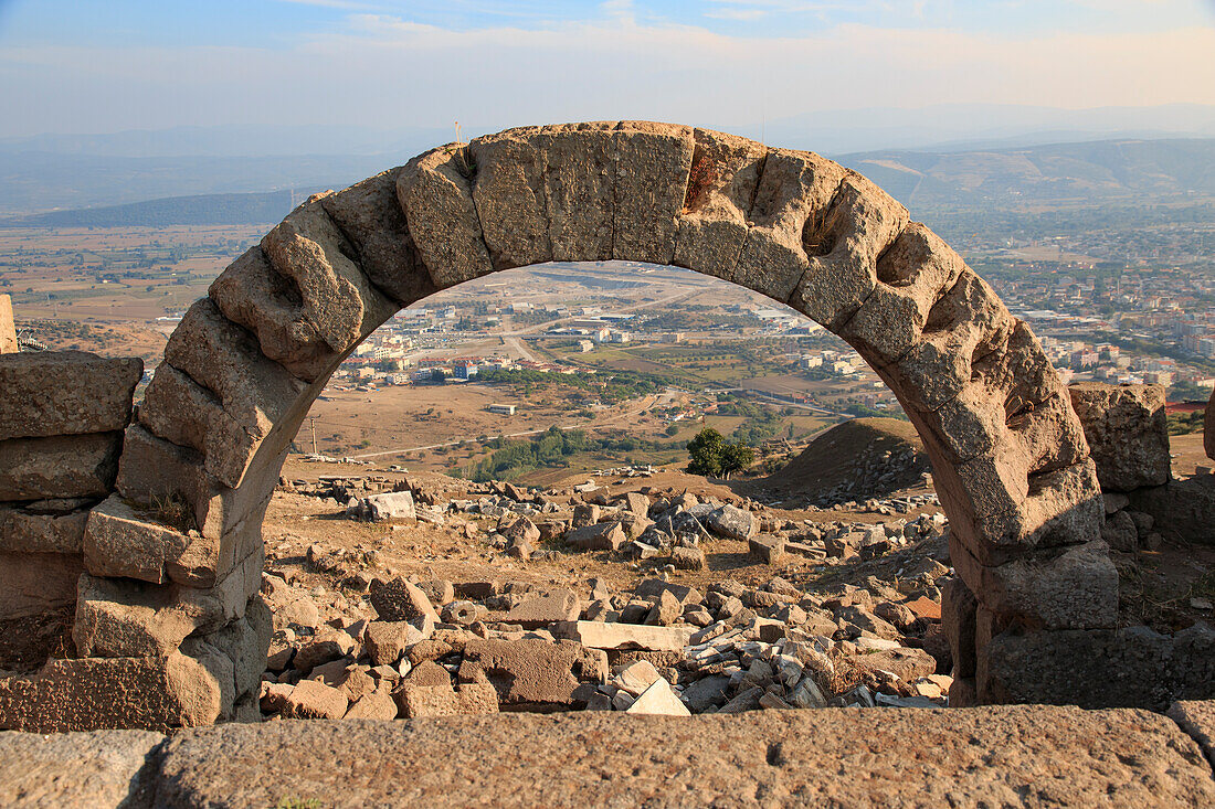 Turkey, Izmir Province, Bergama, Pergamon. Ancient cultural center. Library arch looks out over modern Bergama city. UNESCO Heritage Site.