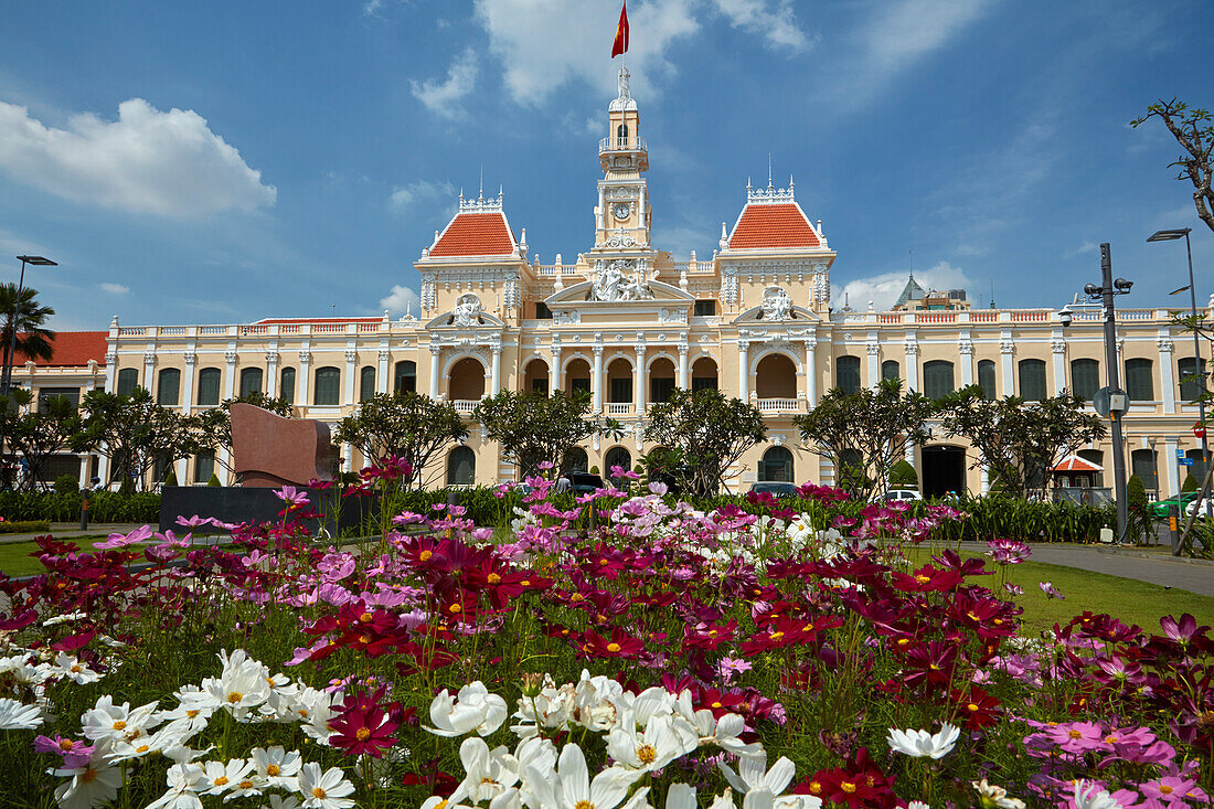 Flowers and historic People's Committee Building (former Hotel de Ville de Saigon), Ho Chi Minh City (Saigon), Vietnam