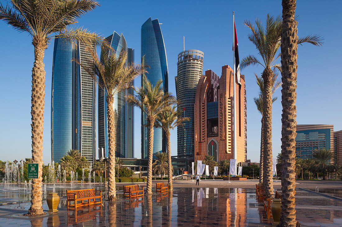 UAE, Abu Dhabi. Etihad Towers and Emirates Palace Hotel fountains