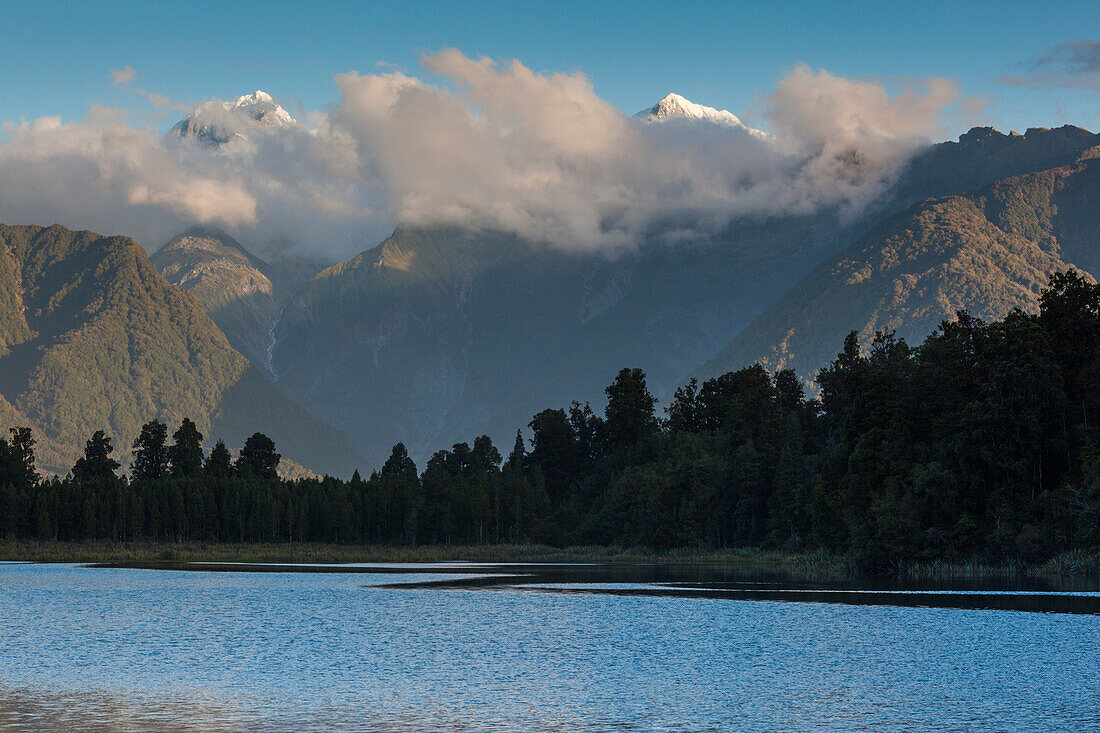 New Zealand, South Island, West Coast, Fox Glacier Village, Lake Matheson, reflection of Mt. Tasman and Mt. Cook, dusk