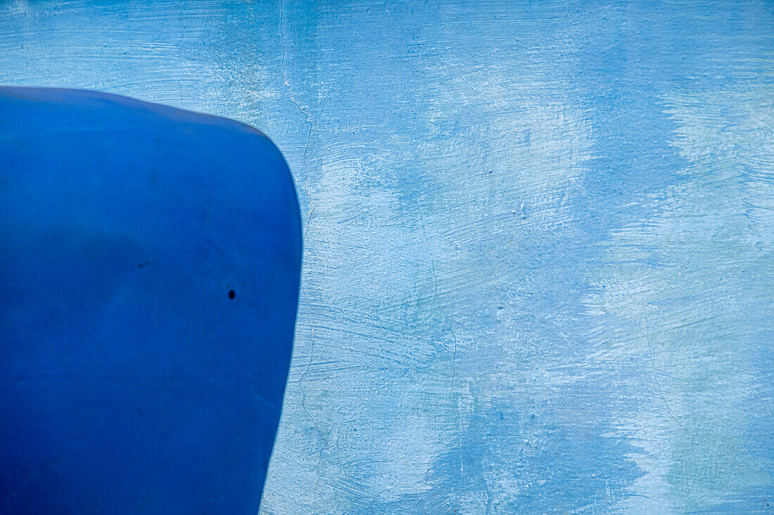 Blue front car fender next to blue painted wall in Vinales, Vinales Valley, Cuba.