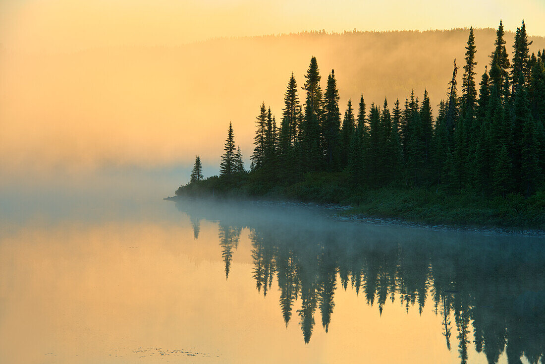 Canada, Quebec, Chibougamau. Lake in fog at sunrise