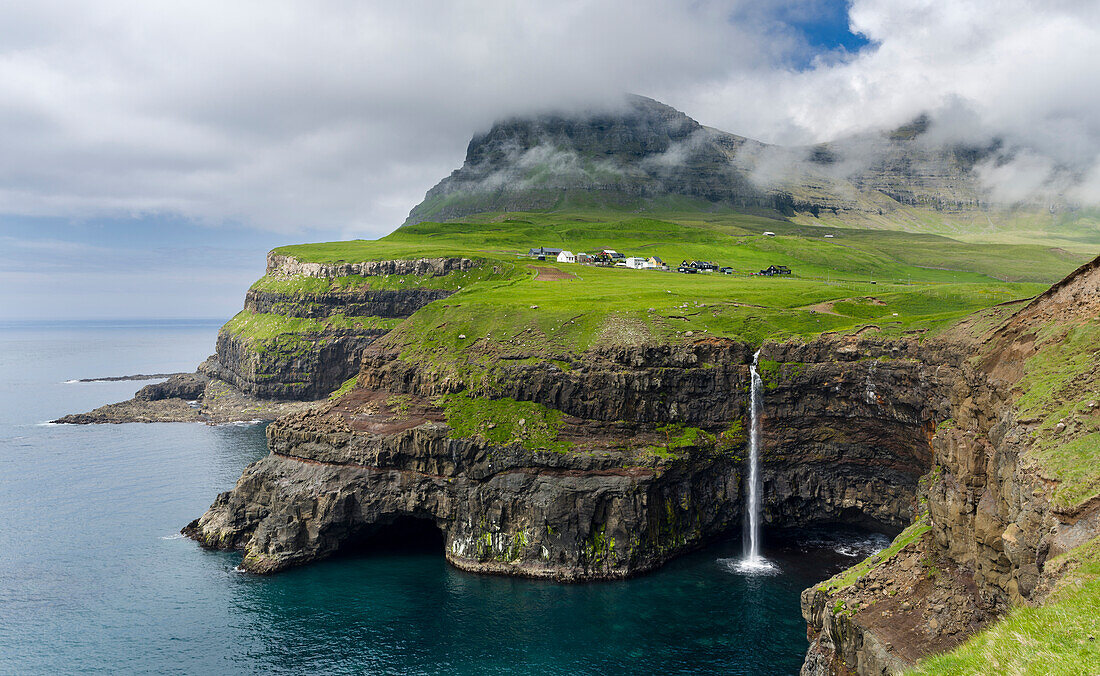 Waterfall Near Gasadalur, One Of The Landmarks Of Faroe Islands. Island Vagar, Part Of The Faroe Islands In The North Atlantic. Denmark