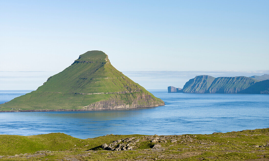 Koltur island at sunrise, the island Vagar in the background The island Streymoy, one of the two large islands of the Faroe Islands in the North Atlantic. Denmark, Faroe Islands