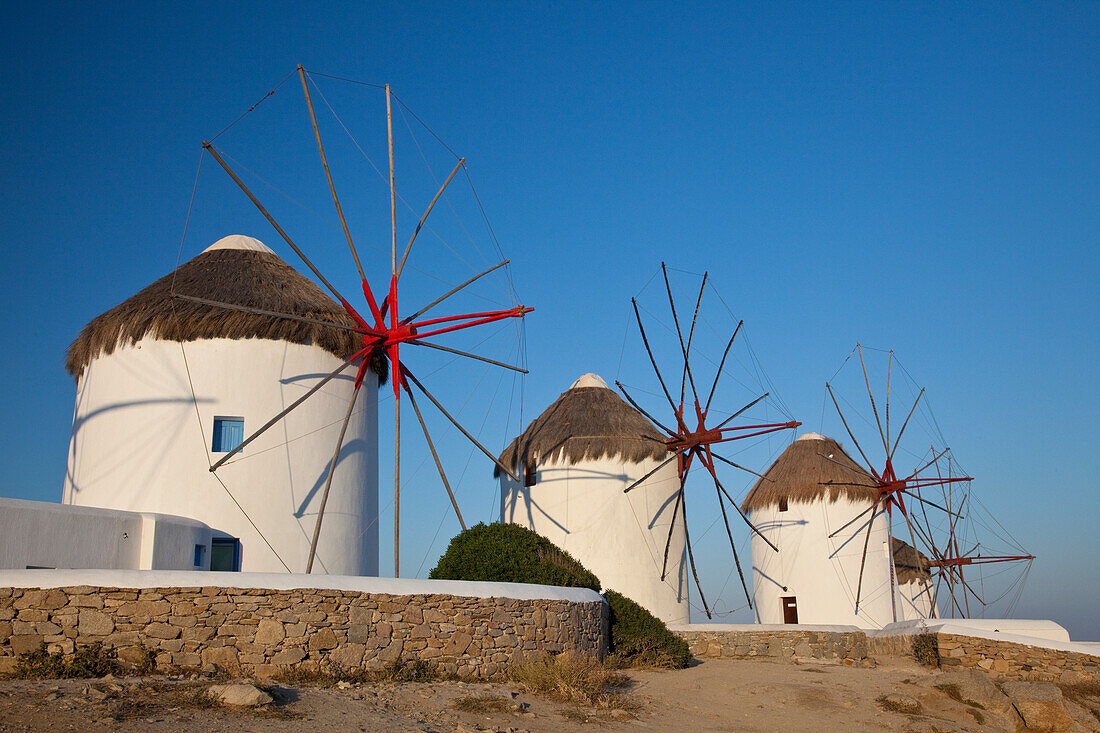 Greece, Mykonos. Windmills along the water
