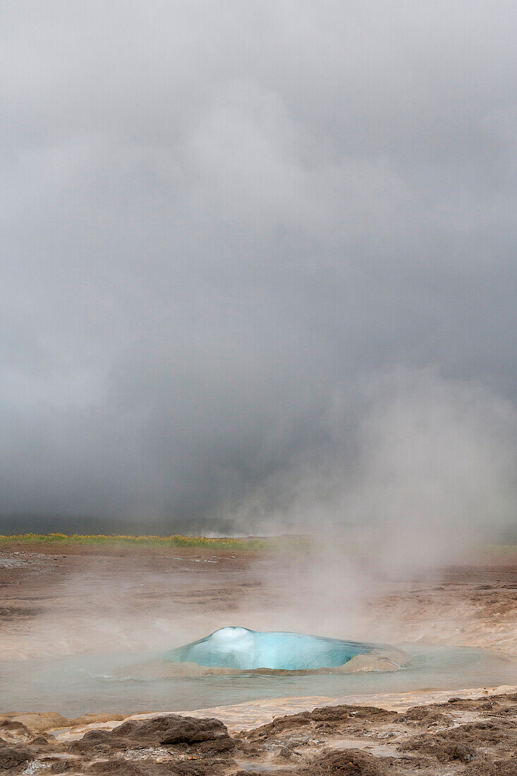 Europa, Island, Goldener Kreis. Der Geysir Strokkur bricht mit viel Dampf aus.