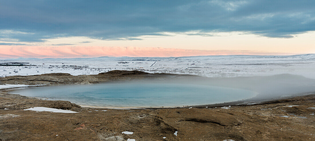 The pool of the gushing spring called Geysir, eponymous for such springs. The geothermal area Haukadalur part of the touristic route Golden Circle during winter. Iceland (Large format sizes available)