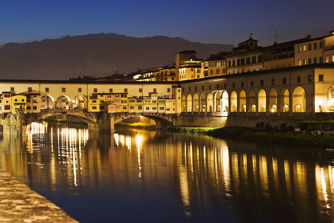 Italy, Florence. River Arno and the Ponte Vecchio at night