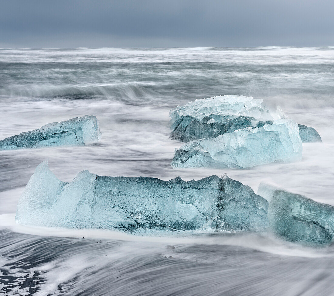 Icebergs on black volcanic beach near the Jokulsarlon glacial lagoon and Breithamerkurjokull glacier in the Vatnajokull National Park, Iceland.