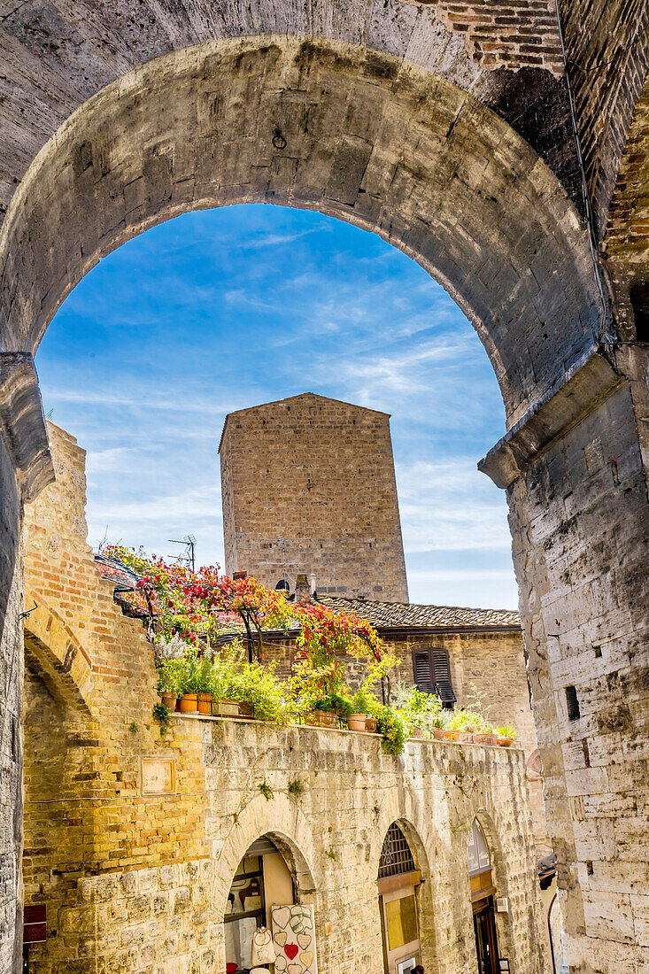 Mittelalterlicher Steinbogen und Turm, San Gimignano, Toskana, Italien.
