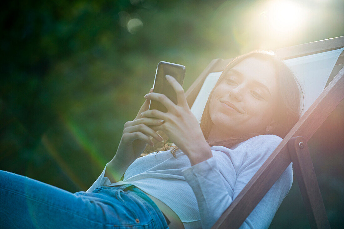 Young woman using smartphone in park