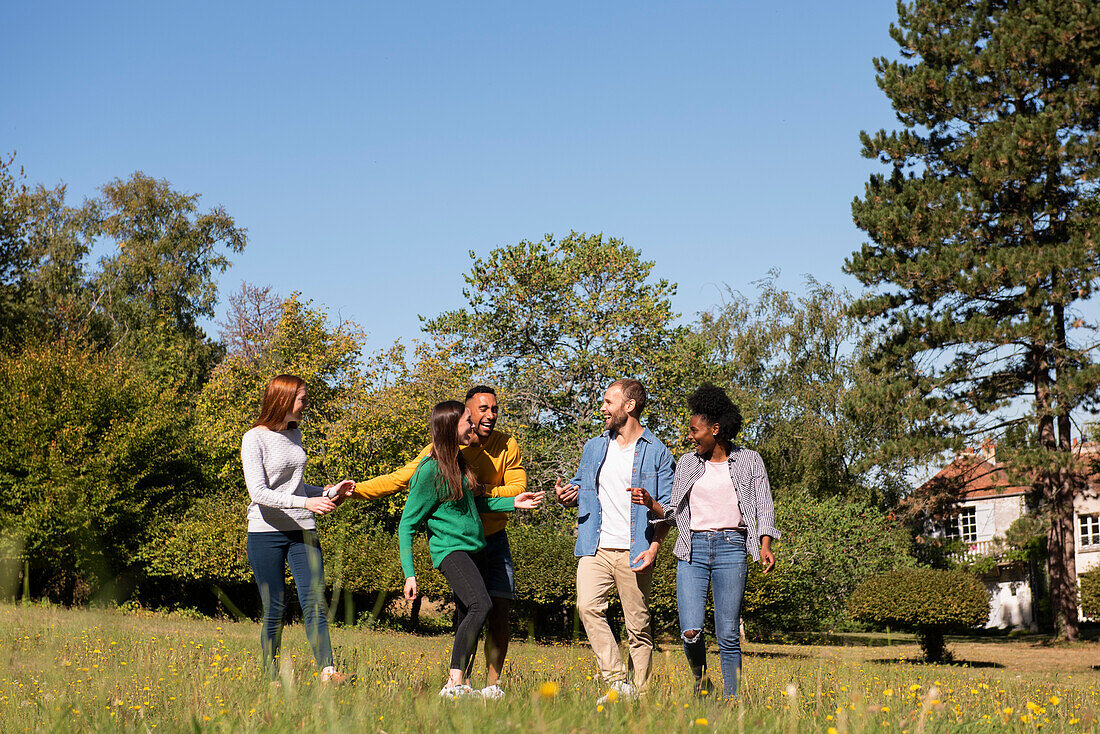 Happy young friends having fun in public park