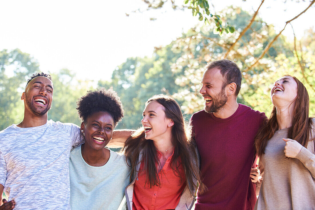 Portrait of smiling young friends standing in park