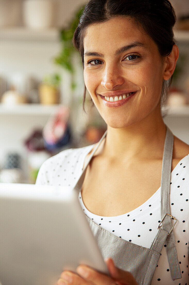 Young adult female entrepreneur smiling at the camera