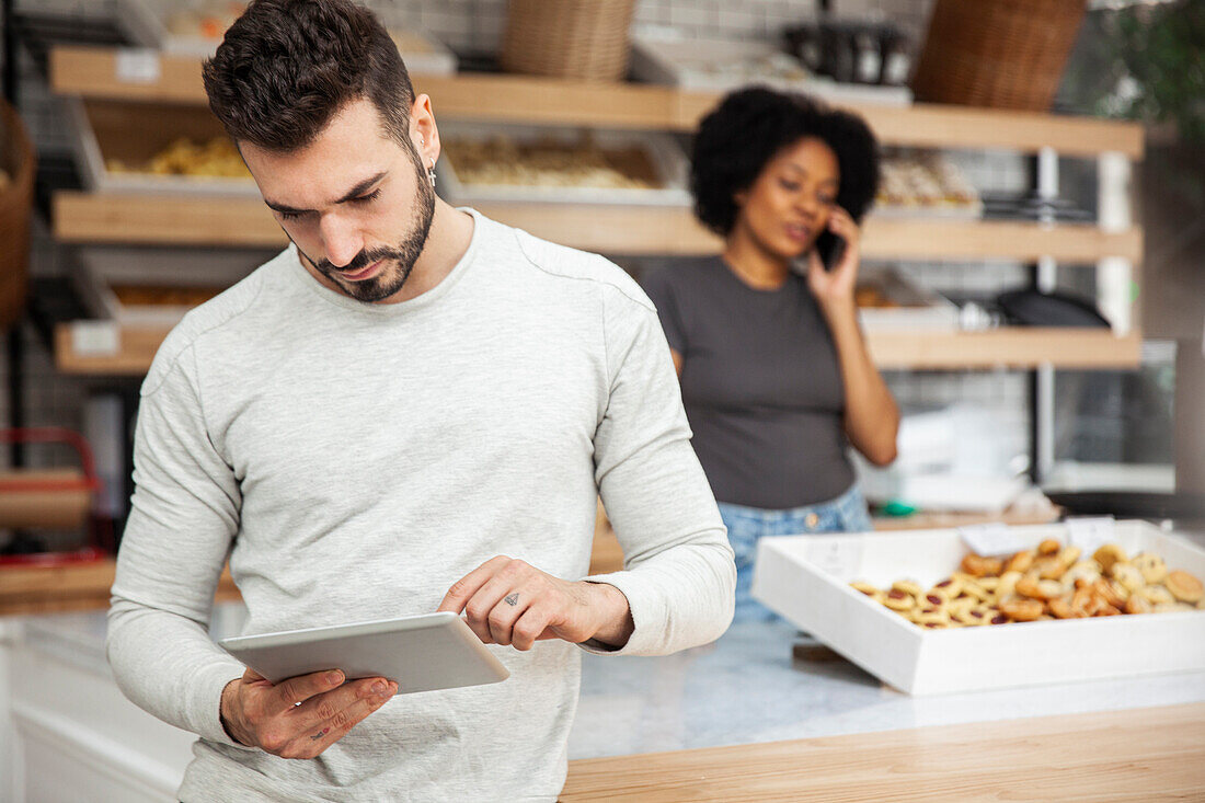 Bakery owner setting up online store on digital tablet