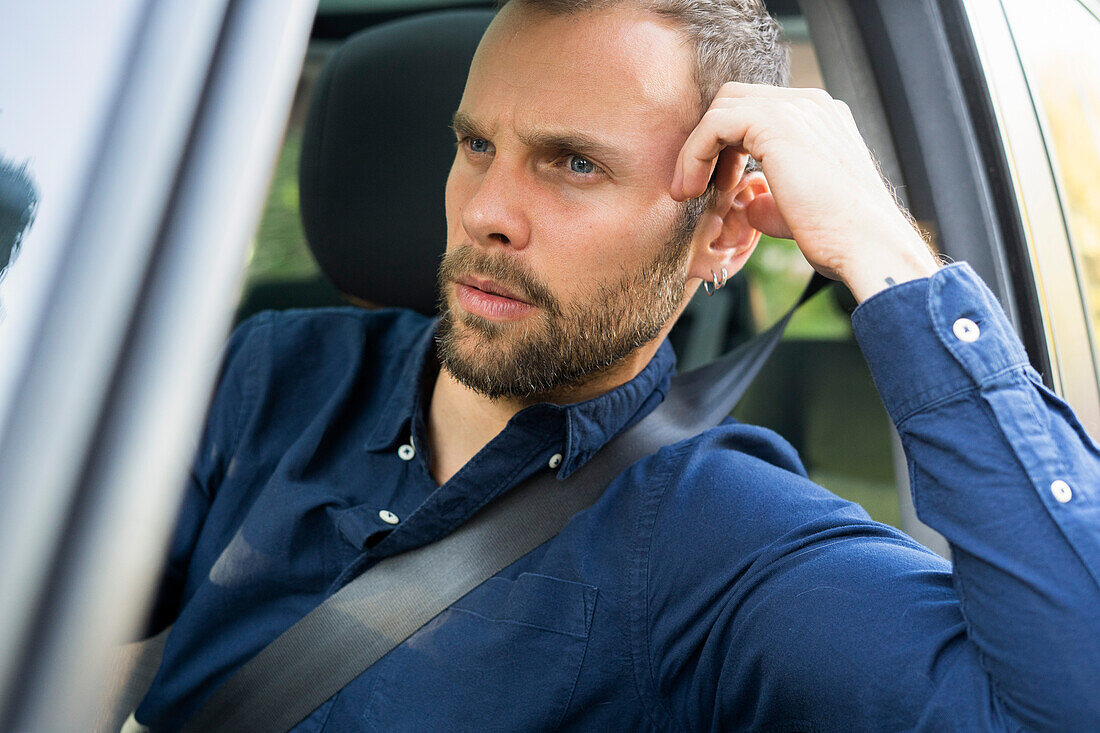 Thoughtful young man in road trip