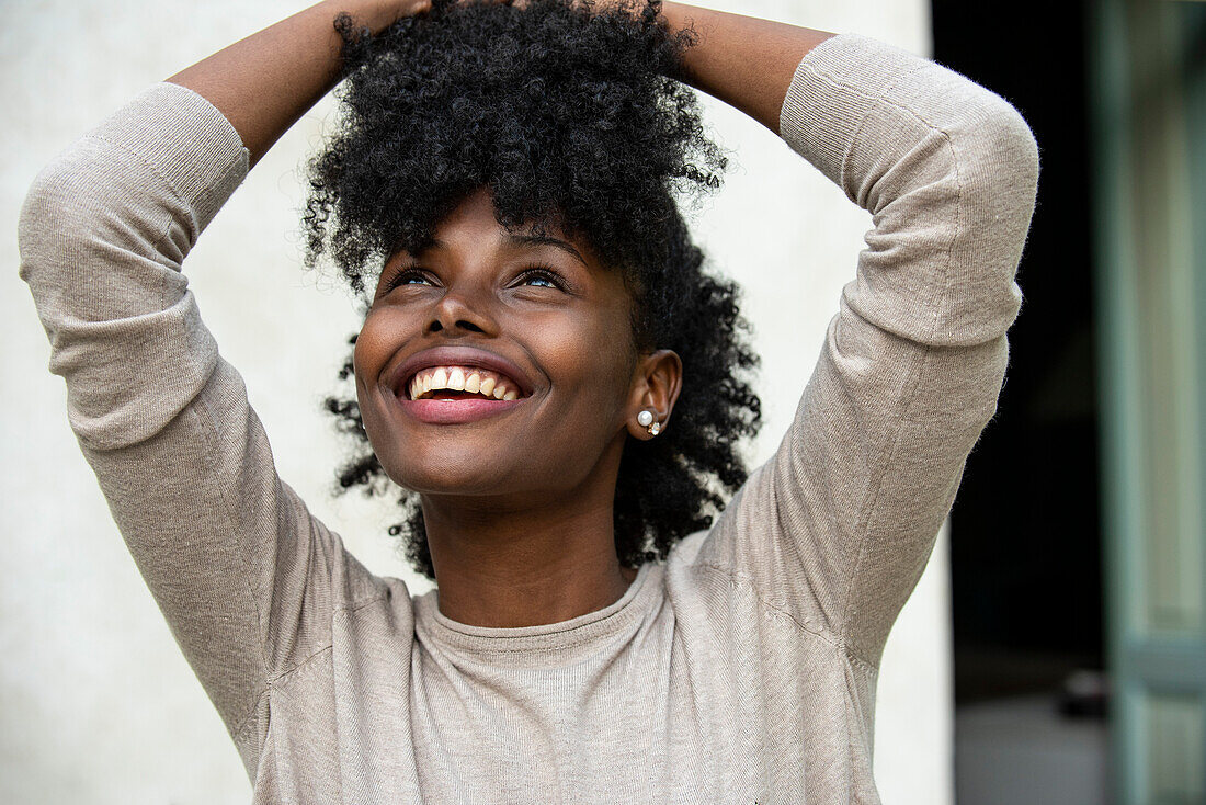 Smiling young woman looking up in park