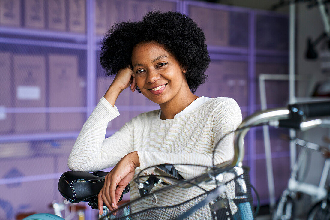Mid-shot portrait of African-American woman standing in her bicycle shop