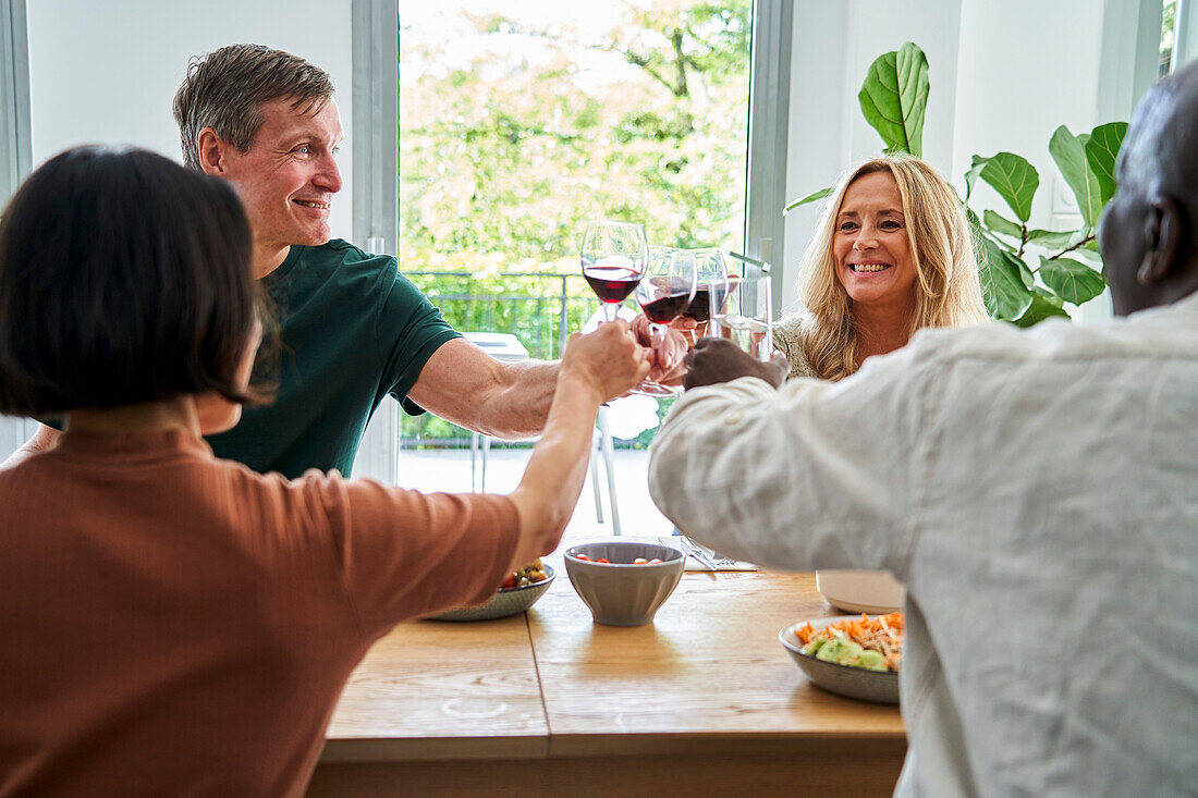 Senior diverse couples making a toast and celebrating