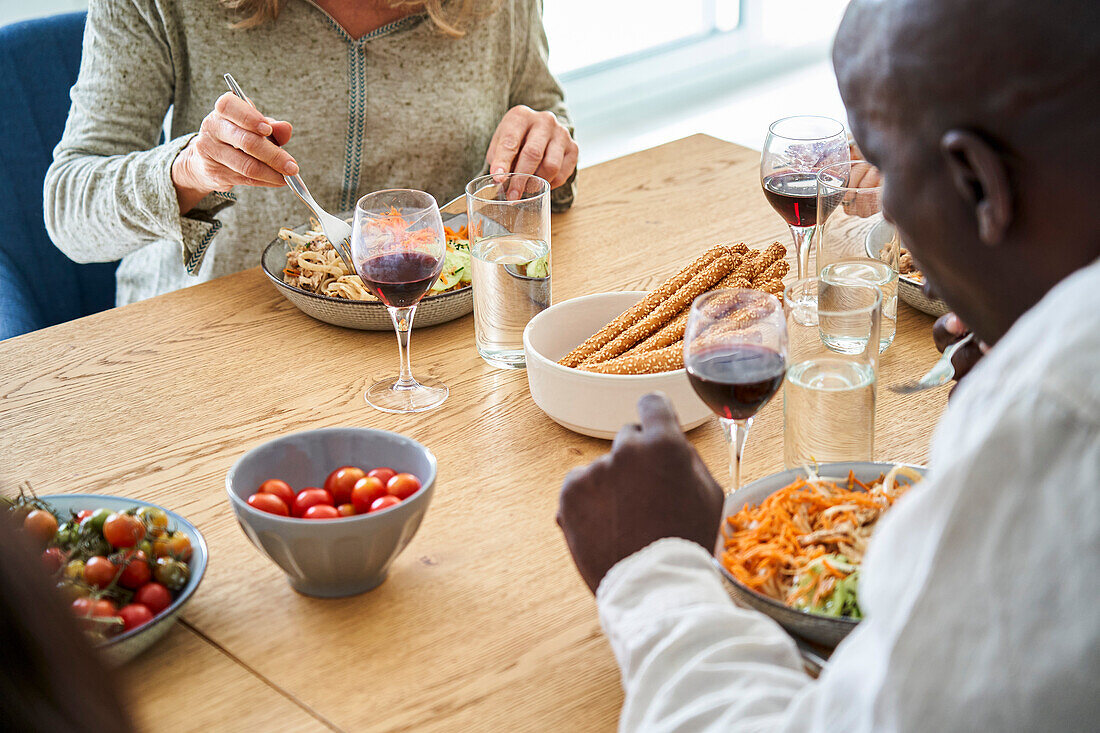 Rear shot of African-American man having a meal with friends