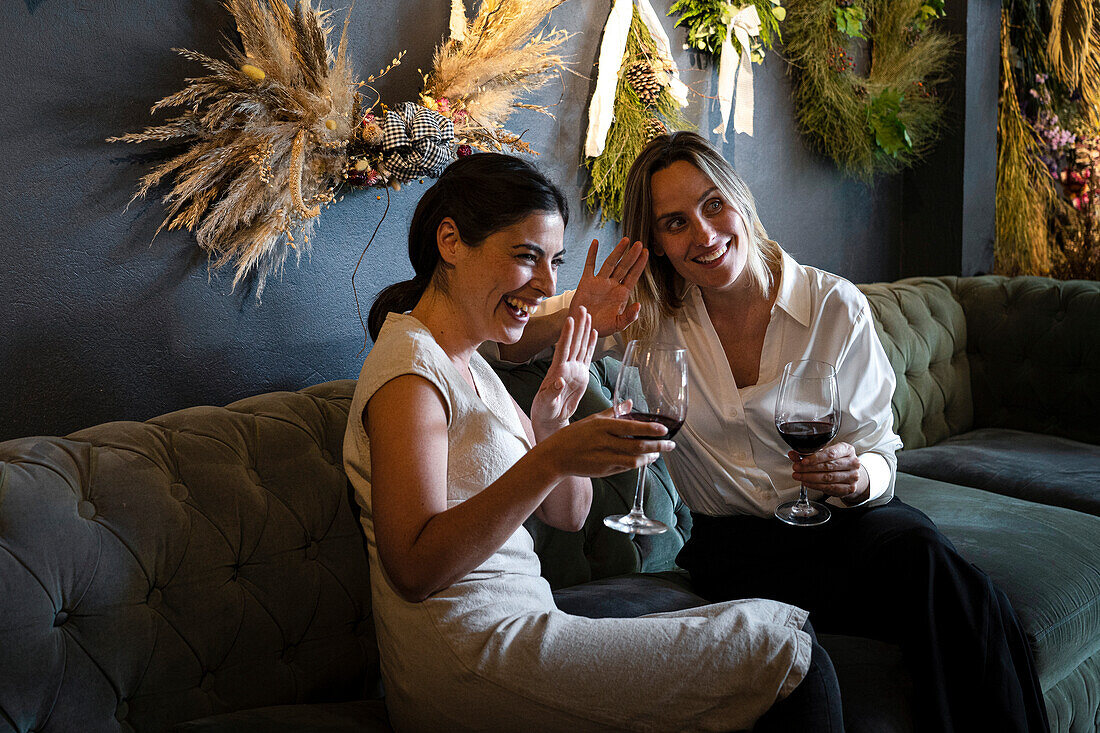 Two diverse female decoration shop owners celebrating the opening of their new business