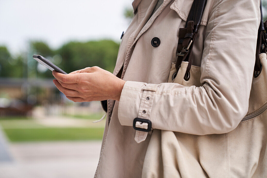 Medium shot of woman's hands holding a cell phone