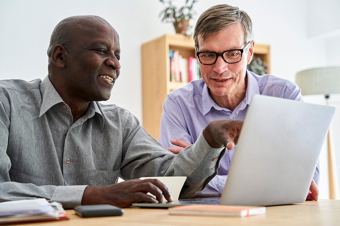 Two male business partners working together at office