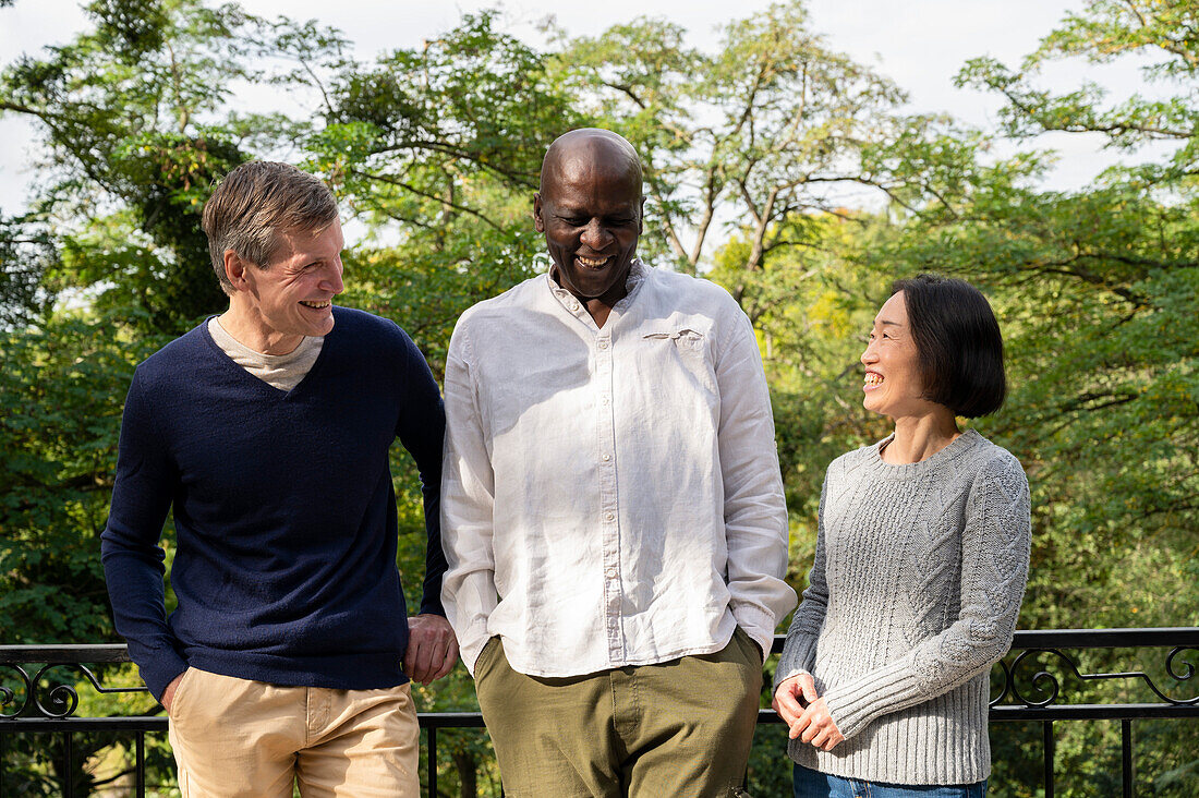 Portrait of diverse group of friends hanging out together outdoors