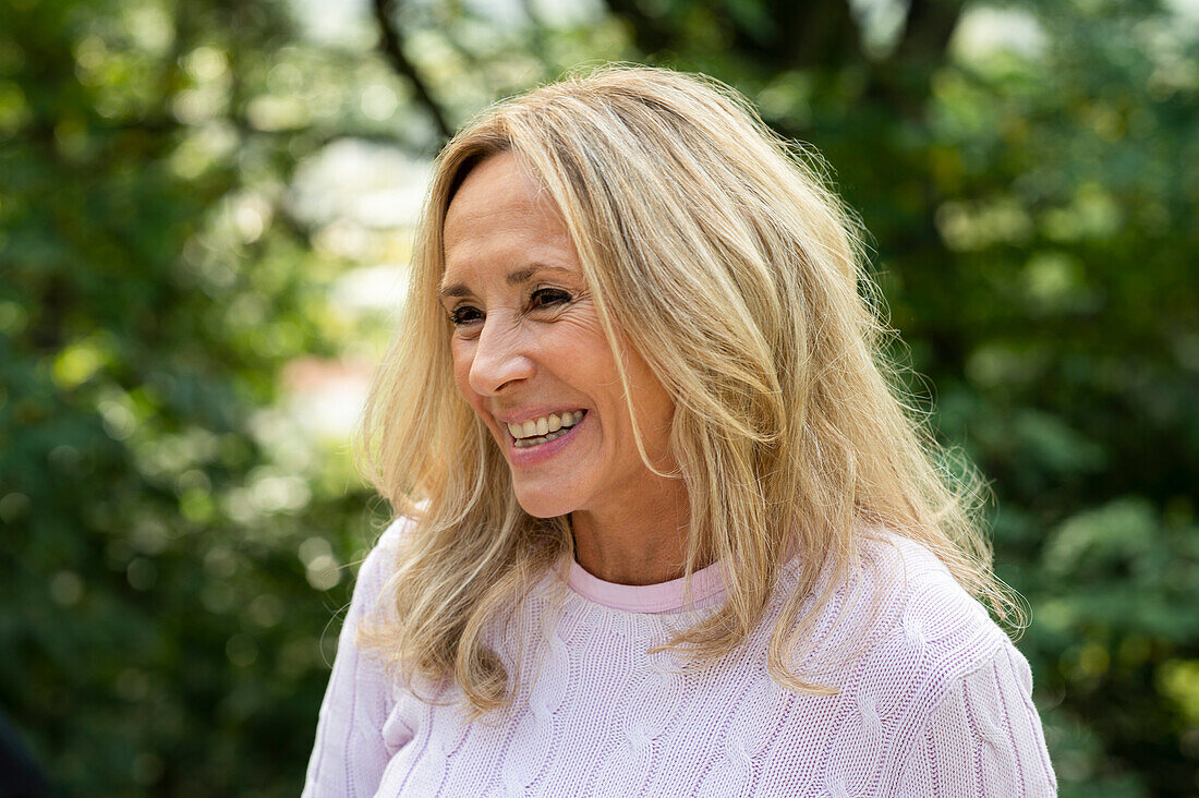 Portrait of middle aged woman smiling while enjoying time outdoors