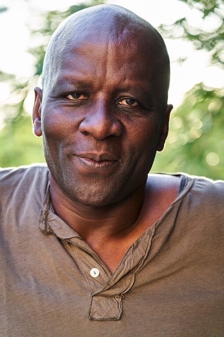 Senior African American man looking at the camera while standing outdoors