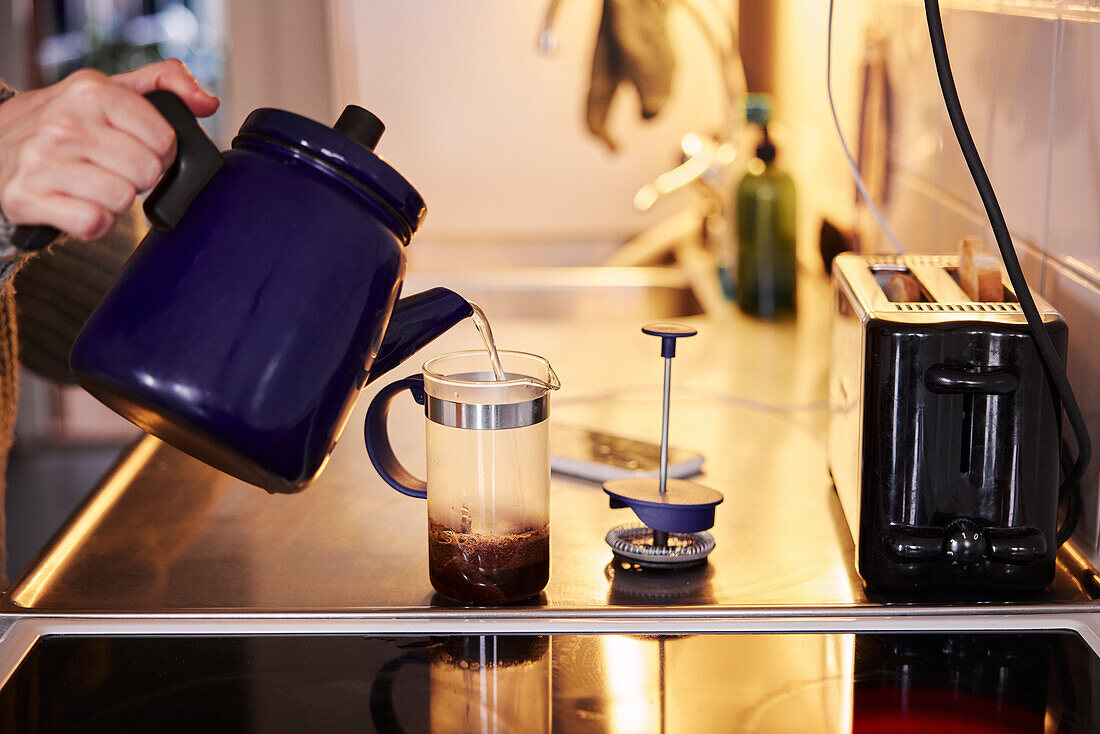 Woman preparing coffee in kitchen