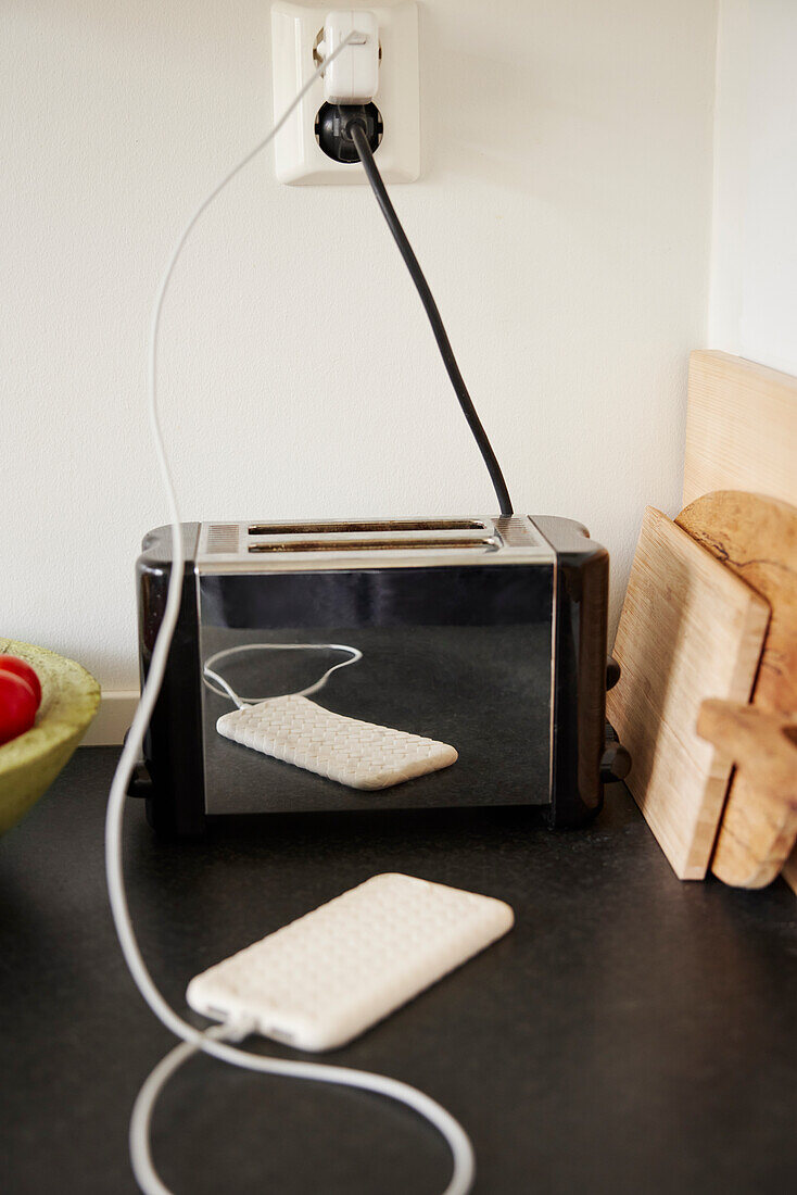 Mobile phone charging on worktop