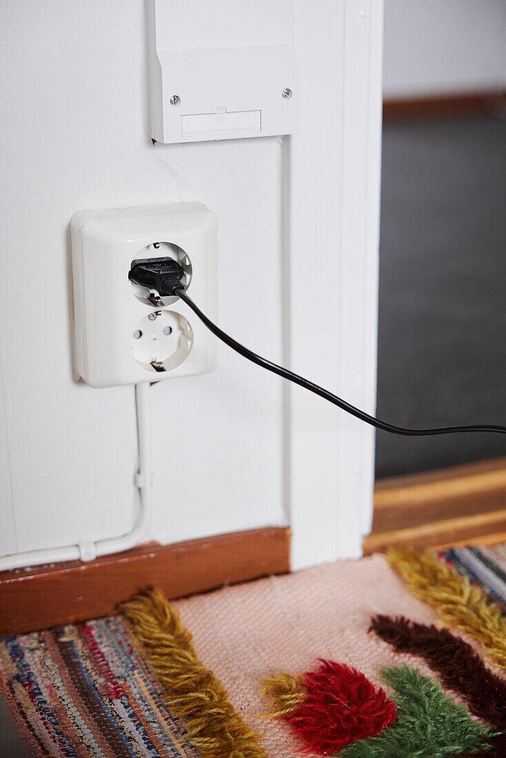 Plug with cable on wall