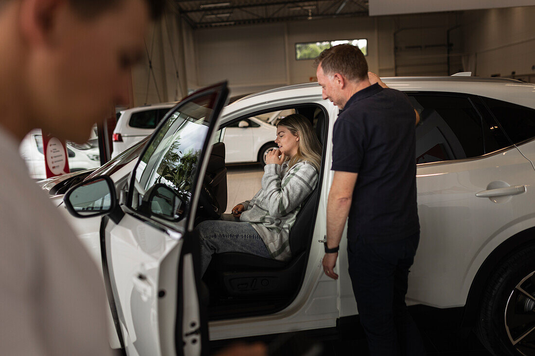 Customers in car dealership office