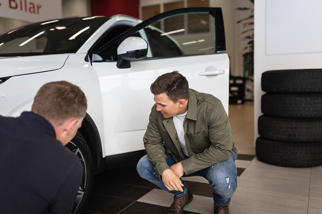 Men in car dealership office