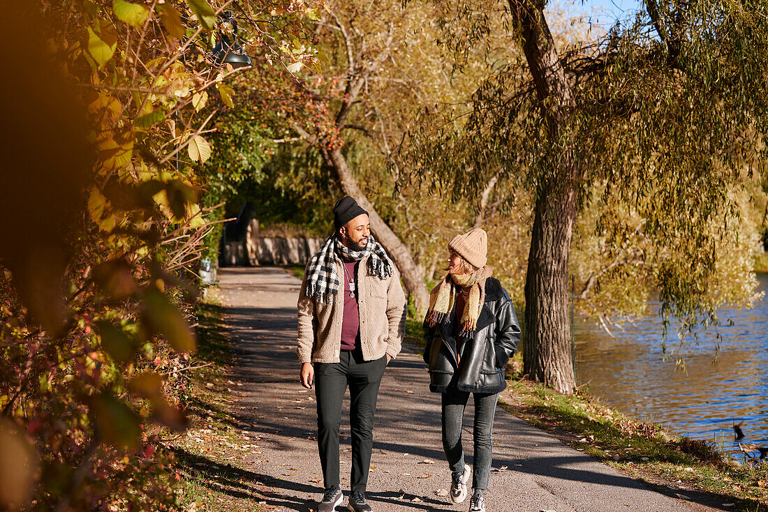 Man and woman walking in autumn park