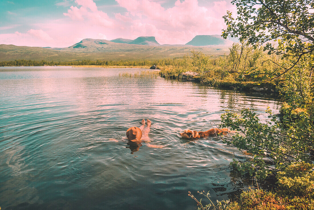 Person mit Hund im See