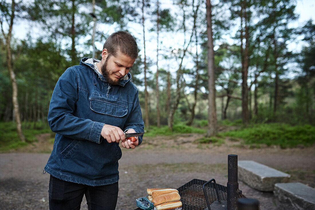 Man preparing hot dog