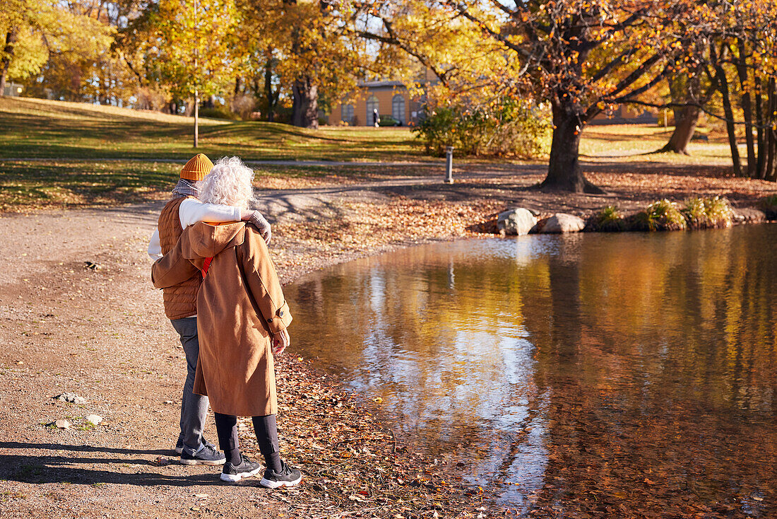 Senior couple next to lake in park