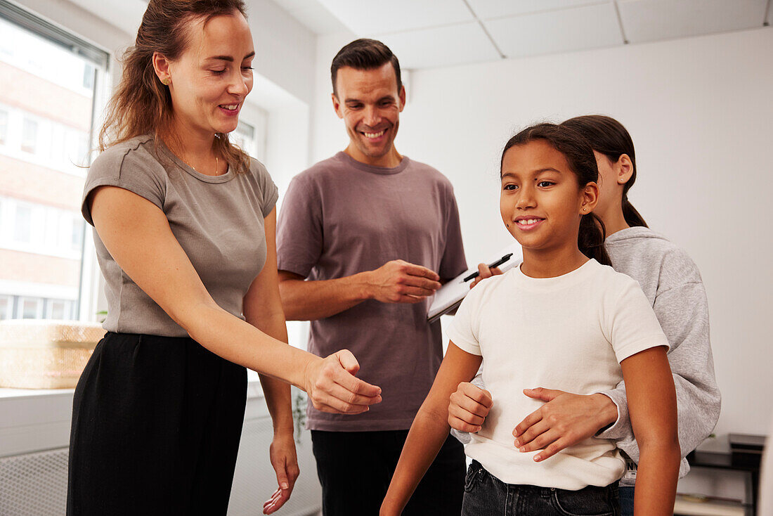 Teachers and children in first aid class