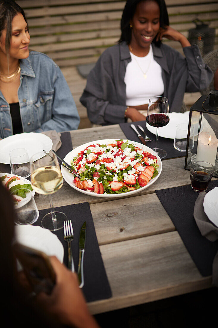 Friends having meal in garden