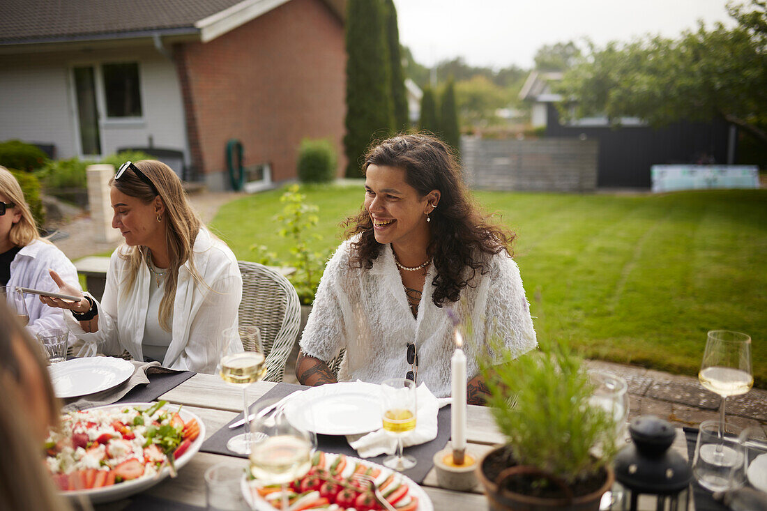 Friends having meal in garden