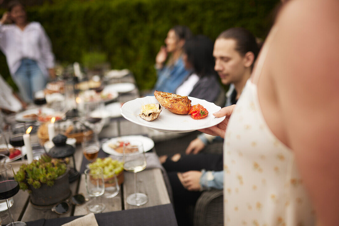 Person holding food on plate