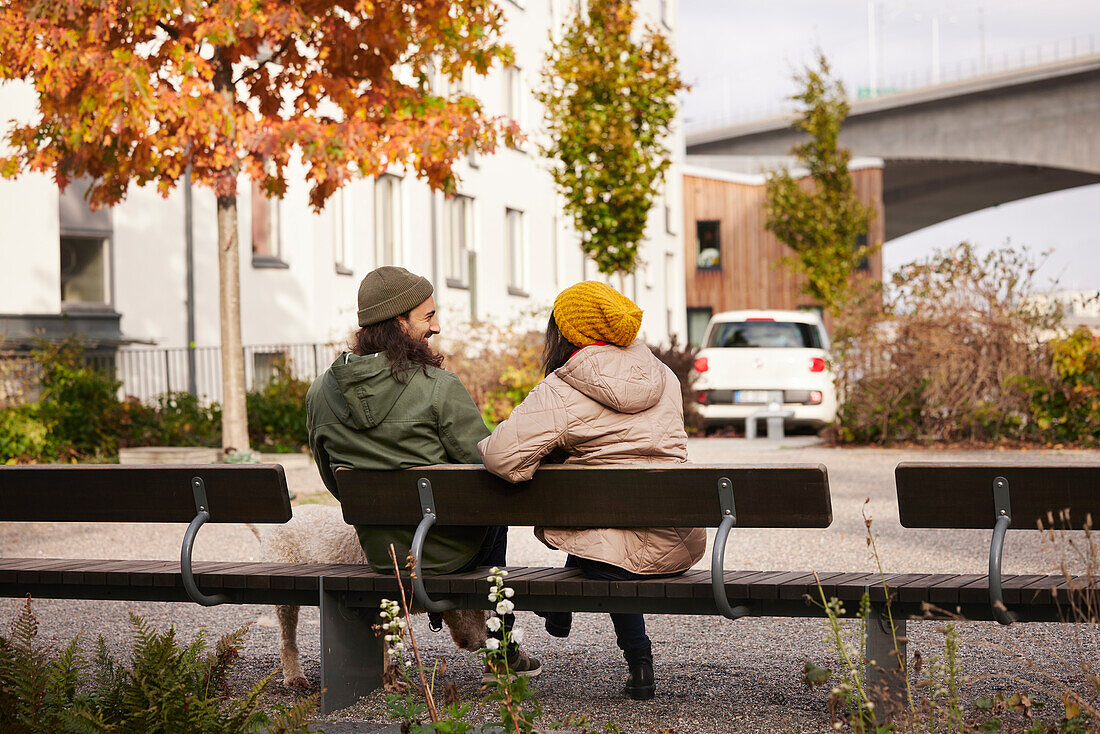 Man and woman sitting on bench