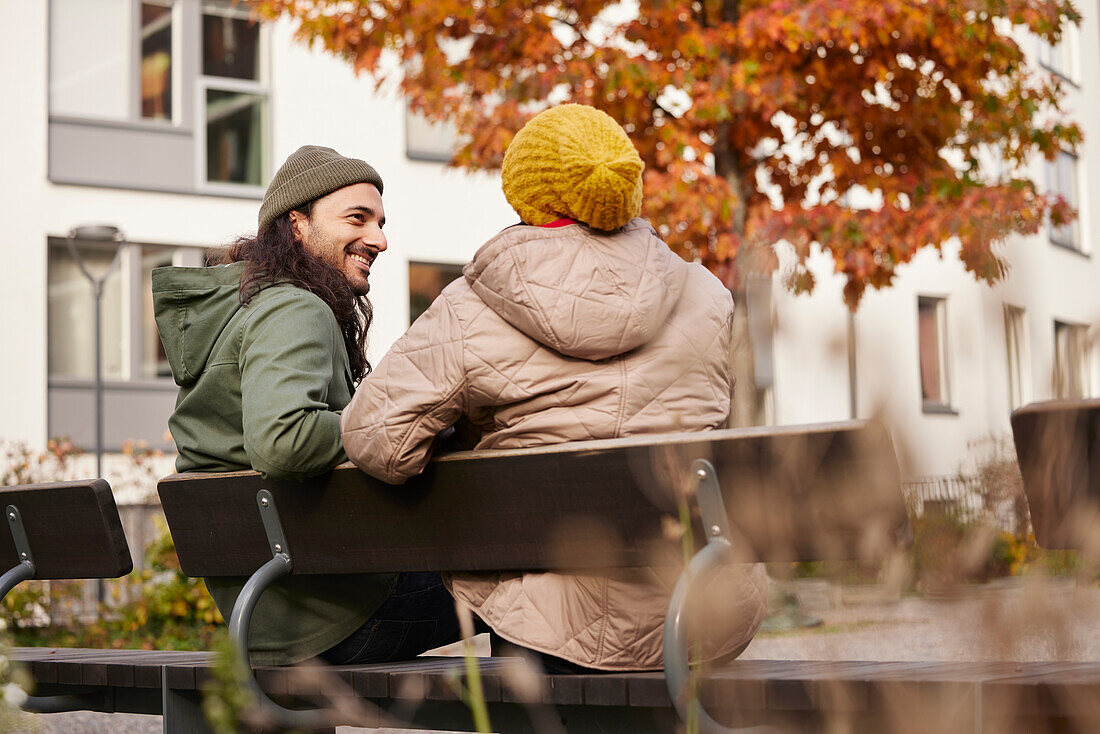 Man and woman sitting on bench