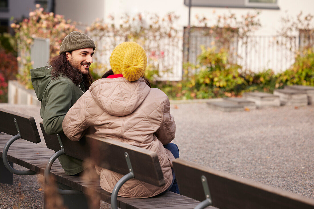 Man and woman sitting on bench