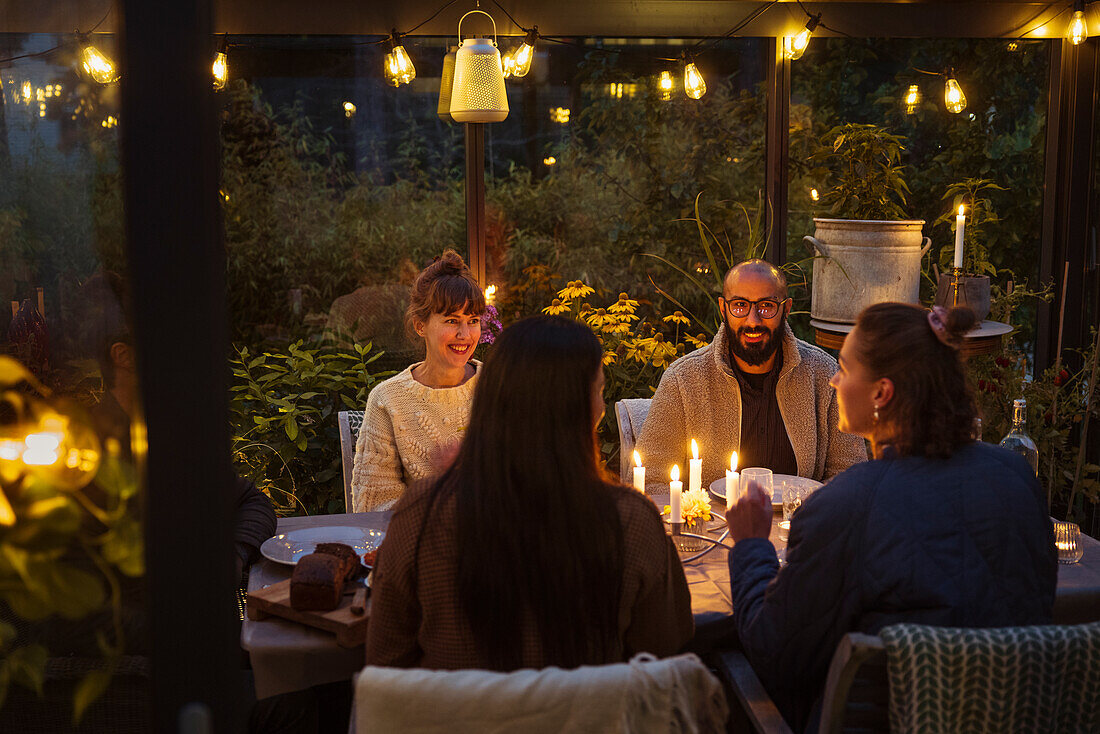 Friends having meal in greenhouse