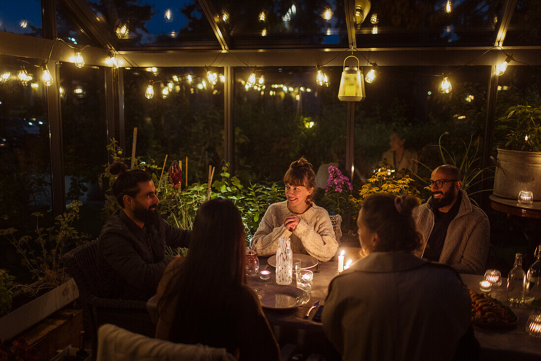 Friends having meal in greenhouse